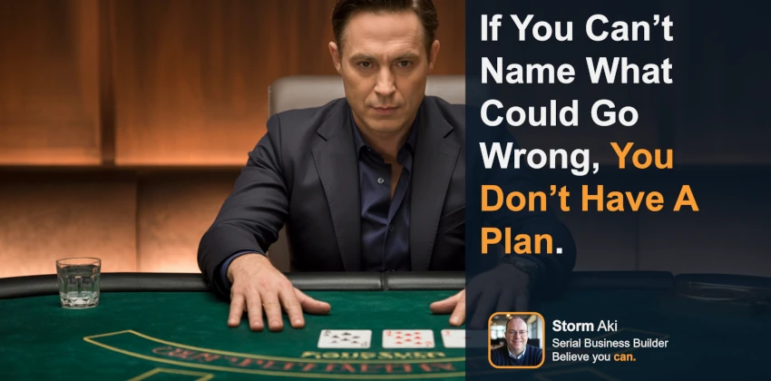 Man sitting at a blackjack table in a suit, staring into the camera and calculating everything that could go wrong